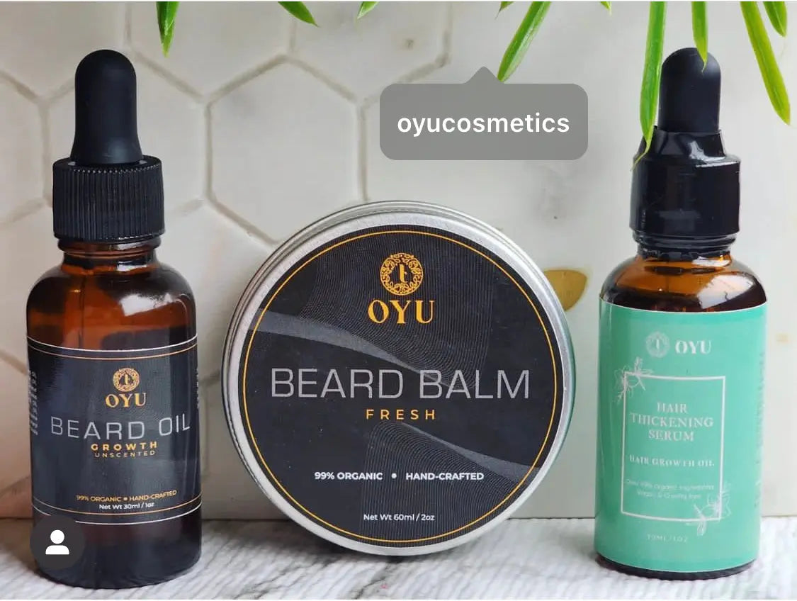 A stylishly arranged collection of beard and hair care products, including bottles of beard oil, shampoo, conditioner, and styling gel, displayed against a clean, modern background."